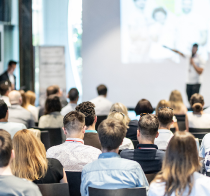 group of speakers at a conference